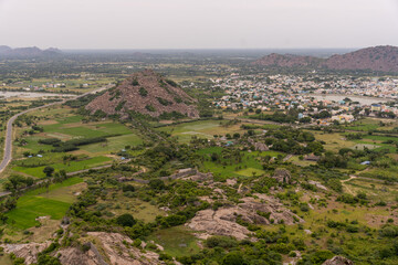 A mountain range with a city in the distance