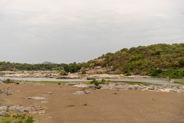 A large body of water is next to a hill