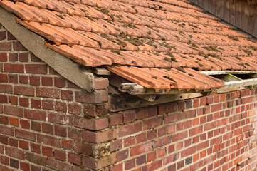 Damaged roof tiles showing neglect requiring renovation and repair