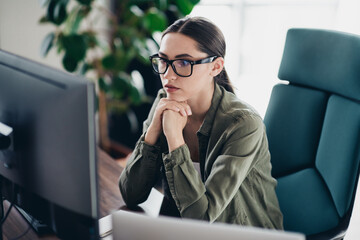 Qualified specialist Working Thoughtfully at a Desktop Computer in a Modern Office Environment