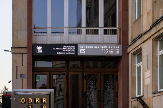 Poznan, Poland - August 10, 2025: Adam Mickiewicz University Collegium Martineum building entrance with Enigma Cipher Centre sign, celebrating Polish cryptologists and code-breaking history