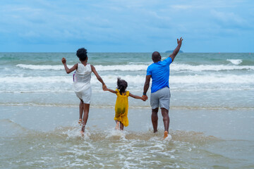 Joyful family enjoys sunny day at beach, splashing in waves and creating lasting memories together....
