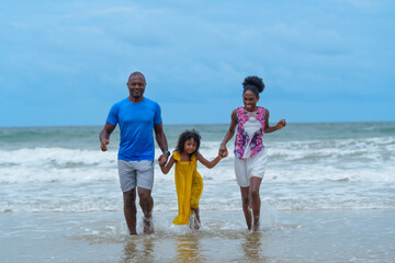 Fototapeta premium Joyful family enjoys sunny day at beach, splashing in waves and creating lasting memories together. vibrant atmosphere reflects their happiness and love