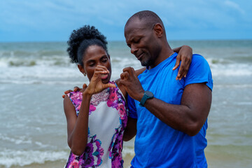 Joyful family enjoys beautiful day at beach, sharing laughter and love while creating lasting...