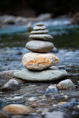 balanced stones in front of river