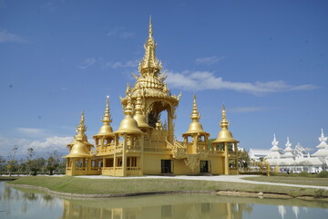 Large gold building with a gold roof and gold spires