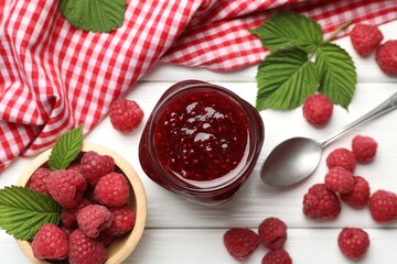 Tasty jam, fresh ripe raspberries and leaves on white wooden table, flat lay.