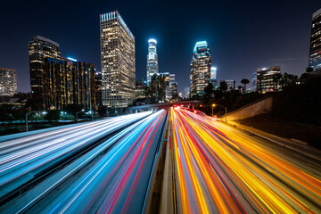 Fototapeta premium Close up, A neon city skyline with light trails of cars at night