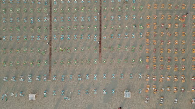 Aerial View of People Gathering: An expansive, high-angle view reveals a dense assembly of people in an outdoor setting, hinting at a communal event or activity. 