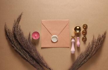 Envelope with Wax Seal Making Kit on Beige Background. Top View. Flat Lay