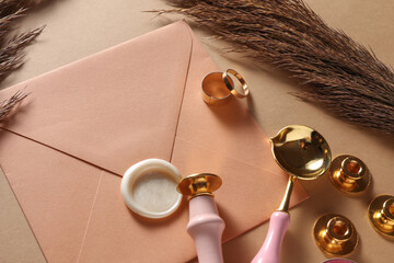 Wedding invitation stationery set. Envelope with sealing wax, vintage stamps and gold rings on...