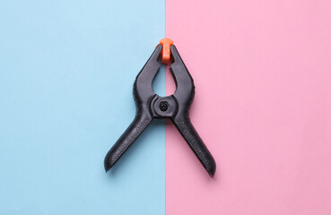 Plastic Spring Clamp on a pink blue background