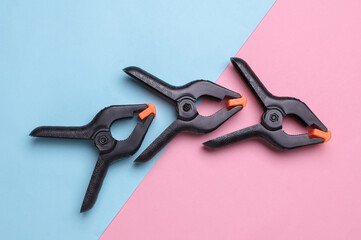 Plastic Spring Clamps on a pink blue background