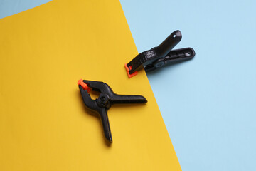 Plastic Spring Clamps on a yellow blue background