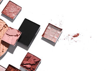 Crushed eyeshadow for makeup. Cosmetic product sample on white background. Creative layout. Beauty make concept. Top view