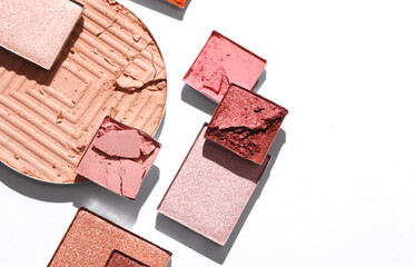 Crushed eyeshadow for makeup. Cosmetic product sample on white background. Creative layout. Beauty make concept. Top view