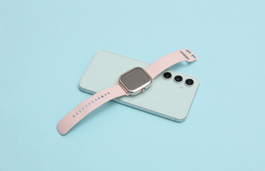 Modern gadgets. Smartphone and smart watch on a blue background