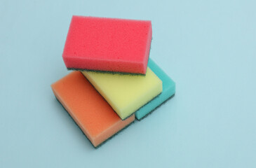Fototapeta premium Set of colored cleaning sponges on a blue background