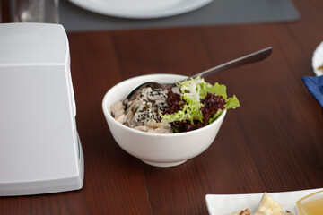 Salad with sesame seeds in a plate on the table