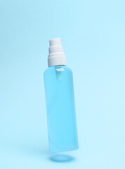 Lotion bottle levitating on blue background