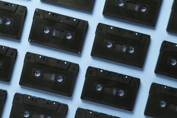 Background of many black audio cassettes. Top view