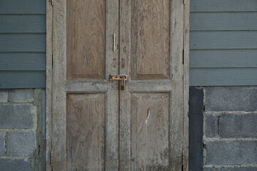Old wooden door with lock and key