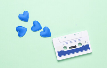 Audio cassette with hearts on green background. Music lover, love song