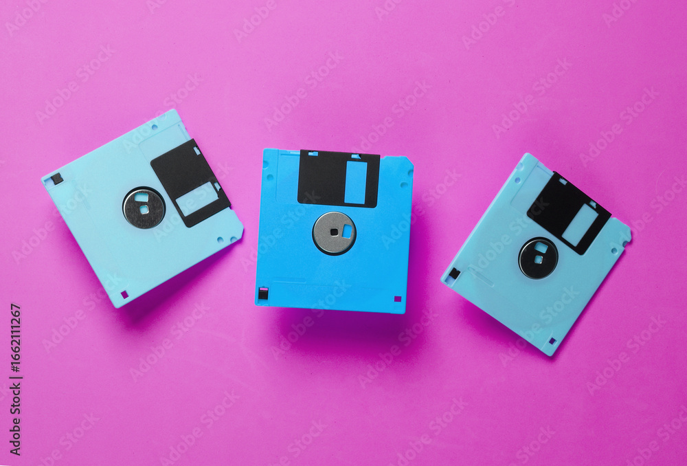 Poster floppy disks on pink background. retro technology. top view