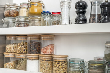 Row upon row of hand-labeled jars containing the secrets of a thousand recipes, each spice with its...