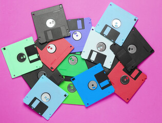 Many colored floppy disks on pink background