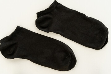 Pair of black sneaker socks on a white background.