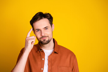 Young man performing thoughtful gesture on vibrant background conveying determination and...