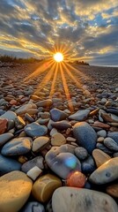 Obraz premium Stunning Sunset Rays on Pebble Beach Stones
