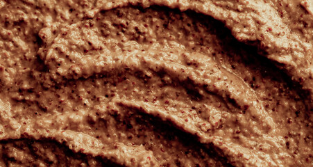 Chocolate ice cream with nuts and banana, texture. Chocolate smoothie cocktail close-up. Nut paste as a background.