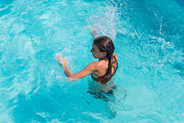 kid girl swimming in pool. selective focus.