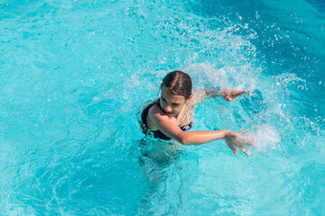 kid girl swimming in pool. selective focus.