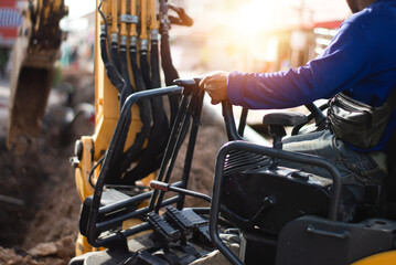 The excavator driver is controlling the operation of the vehicle. © tanit