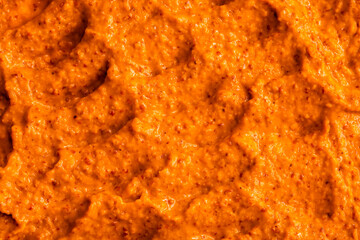 Orange yogurt ice cream with fresh fruits and berries, papaya, grapefruit, pumpkin, persimmon. Smoothie texture. Fruit yogurt ice cream. Delicious sweet dessert close-up as a background.