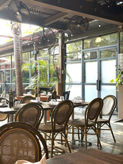 Rustic outdoor dining area with wooden furniture and greenery for relaxed restaurant ambiance, concept of restaurants, cafes, event venues