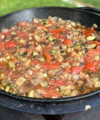 Rustic vegetable ratatouille in cast iron pan for culinary businesses concept of farm-to-table dining