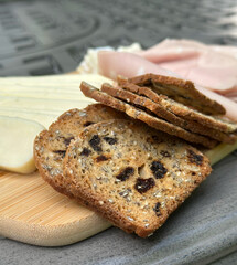 Delicious sliced artisan bread with cheese and ham for gourmet delight - bakery catering, delicatessen, culinary concept