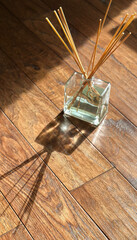 Elegant aroma diffuser casting shadows on wooden floorboards concept of home decor and fragrance by interior designers and lifestyle brands