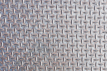 Industrial steel diamond plate surface. Metallic textured background with raised pattern. Durable...