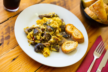 Delicious omelette with with mushrooms and blood sausage served for breakfast..