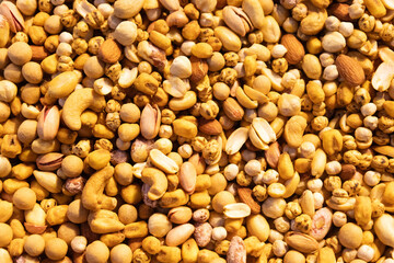 Mixed roasted nuts background closeup