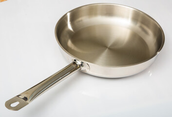 Little long-handled metallic skillet made of light metal used for frying food