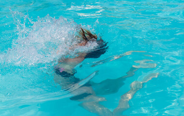 Fototapeta premium kid girl swimming in pool. selective focus.