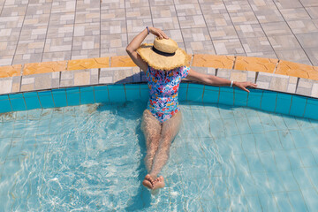 Woman in hat in swimming pool. selective focus.