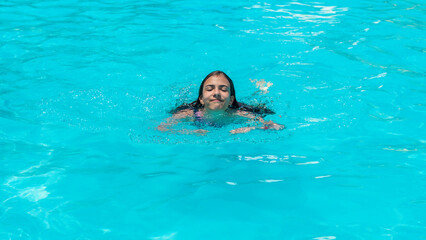 kid girl swimming in pool. selective focus.