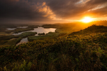 Guidel Morbihan Golden Sunset Over Marshland with Dramatic Clouds